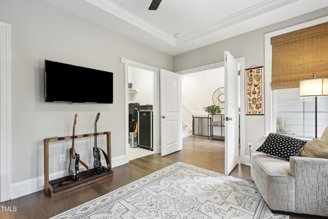 1602 Bowery Dr, Raleigh, NC 27607 - living area featuring wood finished floors, crown molding, stairway, a ceiling fan, and baseboards