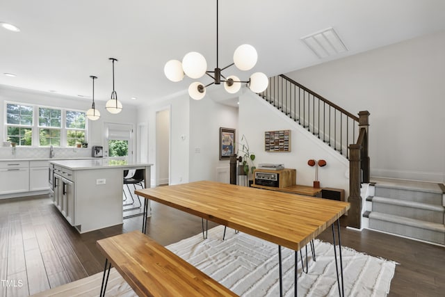 1602 Bowery Dr, Raleigh, NC 27607 - dining room featuring stairway, recessed lighting, dark wood-style flooring, and a chandelier