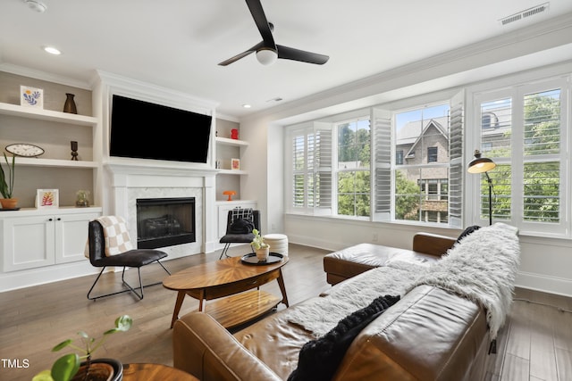 1602 Bowery Dr, Raleigh, NC 27607 - living room with crown molding, baseboards, ceiling fan, a high end fireplace, and wood finished floors