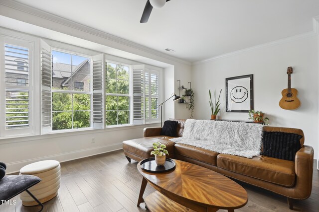 1602 Bowery Dr, Raleigh, NC 27607 - living area with baseboards, crown molding, wood finished floors, and a ceiling fan