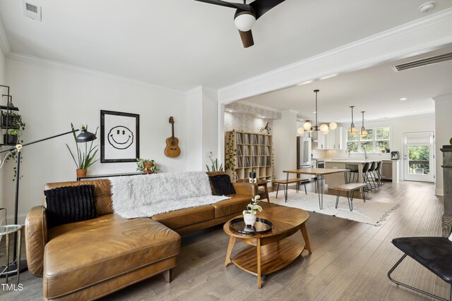 1602 Bowery Dr, Raleigh, NC 27607 - living area with a ceiling fan, crown molding, and wood finished floors