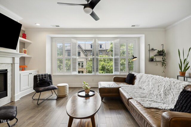 1602 Bowery Dr, Raleigh, NC 27607 - living area with ornamental molding, healthy amount of natural light, a ceiling fan, wood finished floors, and a fireplace