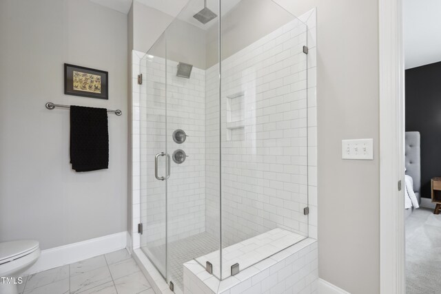 1602 Bowery Dr, Raleigh, NC 27607 - ensuite bathroom with marble look tiles, baseboards, a shower stall, and toilet