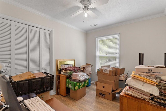 bedroom with light wood finished floors, crown molding, a closet, a textured ceiling, and ceiling fan