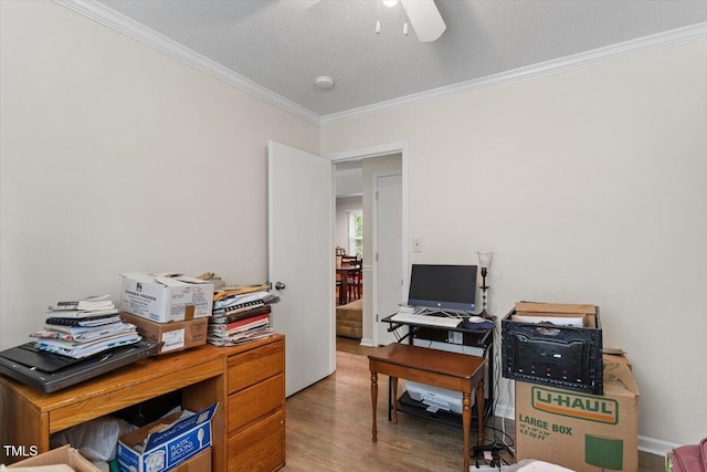 office space featuring crown molding, wood finished floors, ceiling fan, and a textured ceiling