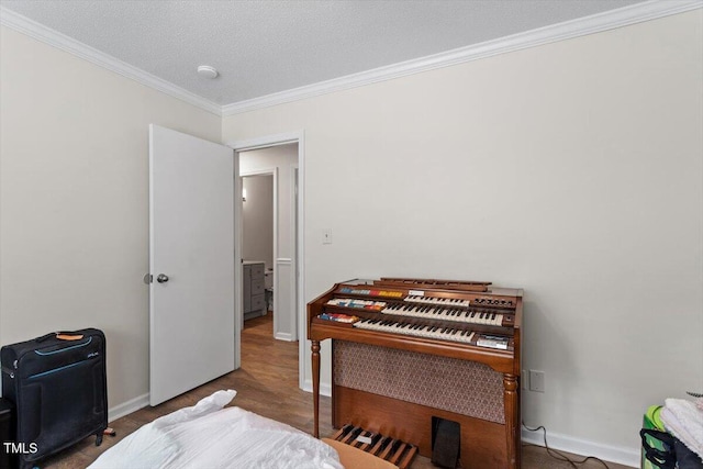 bedroom with crown molding and baseboards
