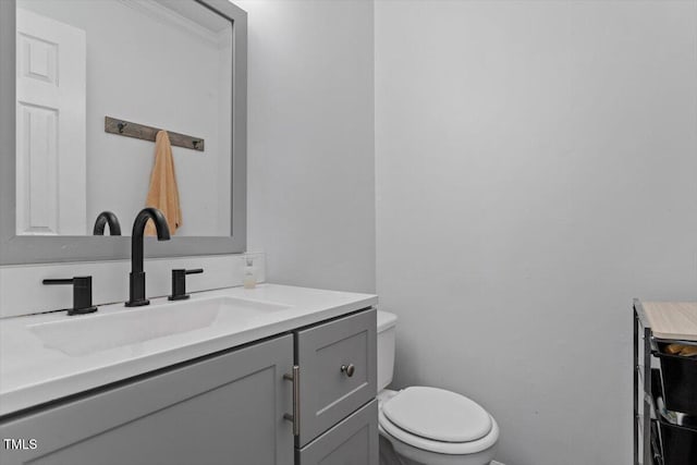 bathroom featuring toilet and vanity