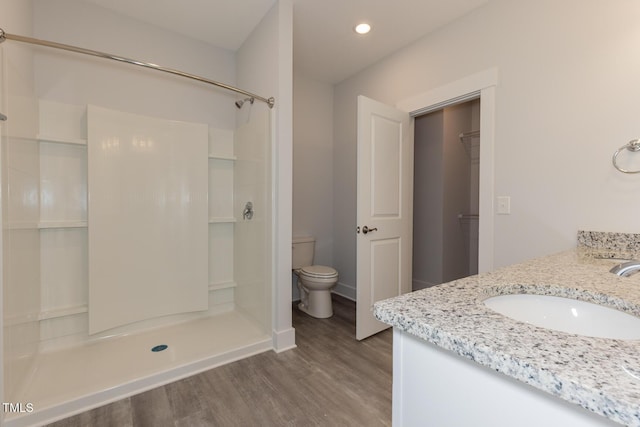 1739 Old Fields Blvd, Haw River, NC 27258 - full bathroom with wood finished floors, toilet, a stall shower, recessed lighting, and baseboards