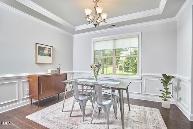2916 Reynolda Cir, Durham, NC 27712 - dining space featuring a chandelier, dark wood-type flooring, a decorative wall, crown molding, and a tray ceiling