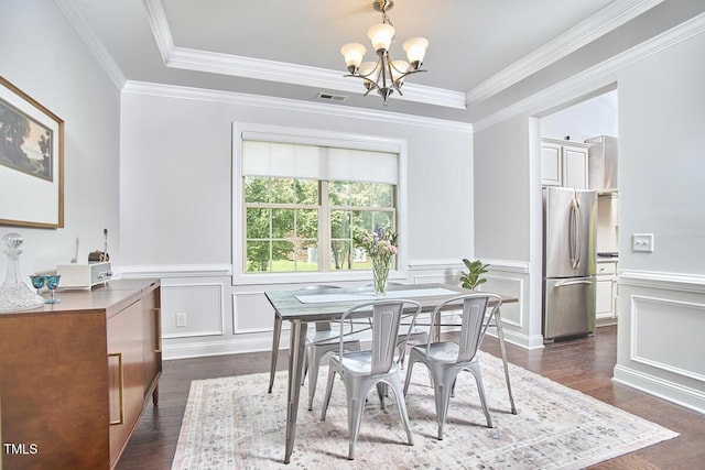 2916 Reynolda Cir, Durham, NC 27712 - dining space with a chandelier, dark wood-type flooring, crown molding, a wainscoted wall, and a decorative wall