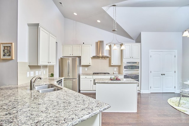 2916 Reynolda Cir, Durham, NC 27712 - kitchen featuring wall chimney exhaust hood, a sink, stainless steel appliances, a kitchen island, and light stone countertops