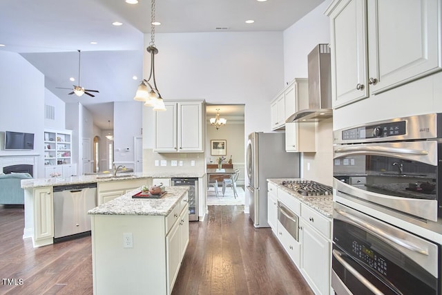 2916 Reynolda Cir, Durham, NC 27712 - kitchen with appliances with stainless steel finishes, wall chimney exhaust hood, a warming drawer, ceiling fan, and high vaulted ceiling
