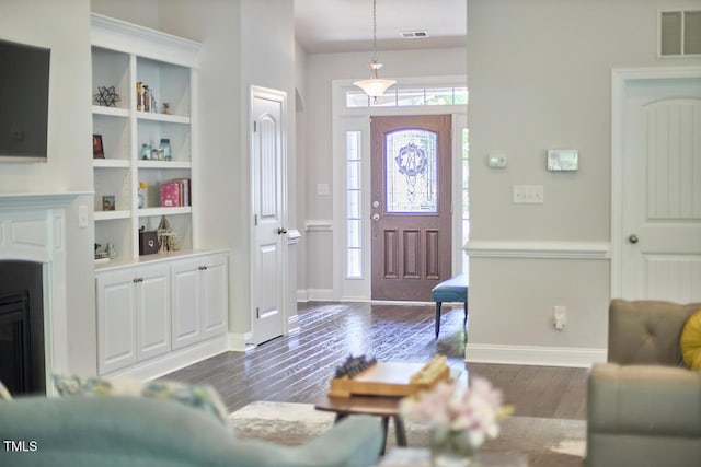 2916 Reynolda Cir, Durham, NC 27712 - foyer entrance with dark wood-type flooring, a fireplace, and baseboards