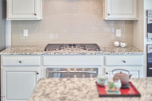 2916 Reynolda Cir, Durham, NC 27712 - kitchen featuring stainless steel gas cooktop, a warming drawer, backsplash, and white cabinets