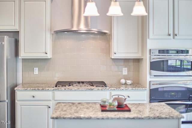 2916 Reynolda Cir, Durham, NC 27712 - kitchen featuring appliances with stainless steel finishes, wall chimney range hood, decorative backsplash, and decorative light fixtures