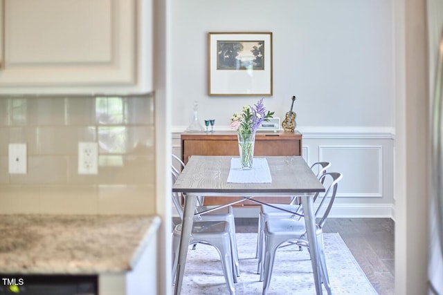 2916 Reynolda Cir, Durham, NC 27712 - dining area featuring wood finished floors, wainscoting, and a decorative wall