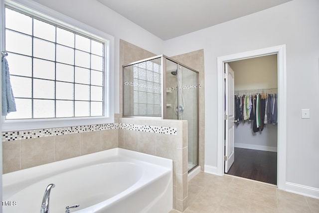 2916 Reynolda Cir, Durham, NC 27712 - bathroom featuring a stall shower, a garden tub, a spacious closet, and tile patterned floors