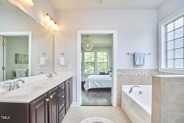 2916 Reynolda Cir, Durham, NC 27712 - ensuite bathroom featuring tile patterned floors, plenty of natural light, a bath, and double vanity