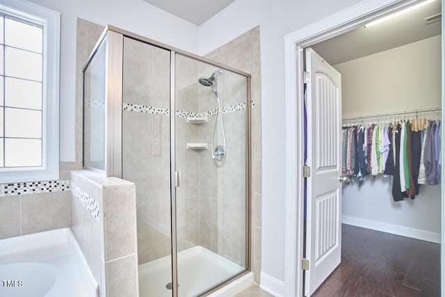2916 Reynolda Cir, Durham, NC 27712 - full bathroom featuring a shower stall, wood finished floors, a garden tub, and baseboards