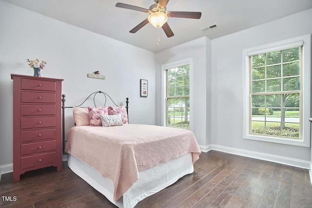 2916 Reynolda Cir, Durham, NC 27712 - bedroom featuring dark wood-style flooring, baseboards, and multiple windows