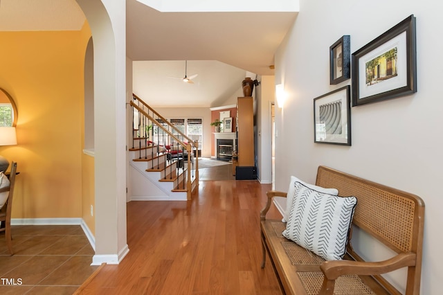 5501 Southern Cross Ave, Raleigh, NC 27606 - hallway with arched walkways, stairway, lofted ceiling, wood finished floors, and baseboards