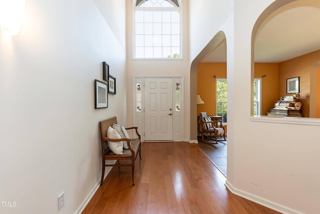 5501 Southern Cross Ave, Raleigh, NC 27606 - foyer entrance featuring arched walkways, wood finished floors, baseboards, and a towering ceiling