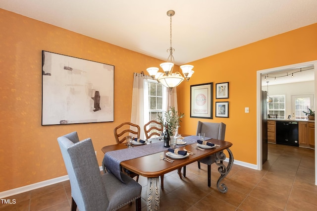 5501 Southern Cross Ave, Raleigh, NC 27606 - dining room featuring a chandelier, dark tile patterned flooring, and baseboards