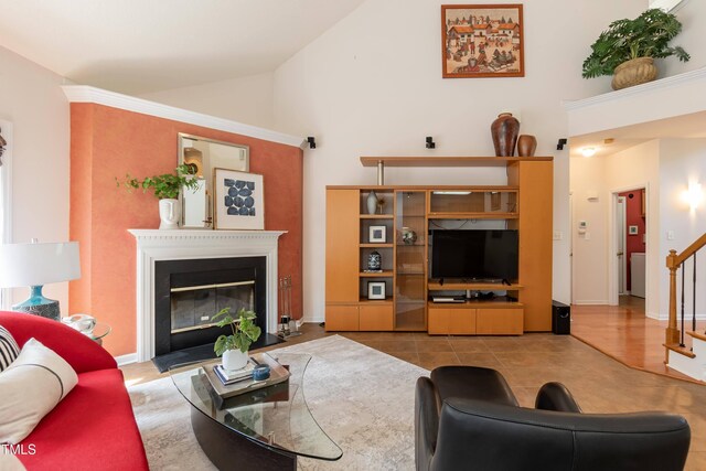 5501 Southern Cross Ave, Raleigh, NC 27606 - living room featuring stairway, high vaulted ceiling, a fireplace with flush hearth, and baseboards
