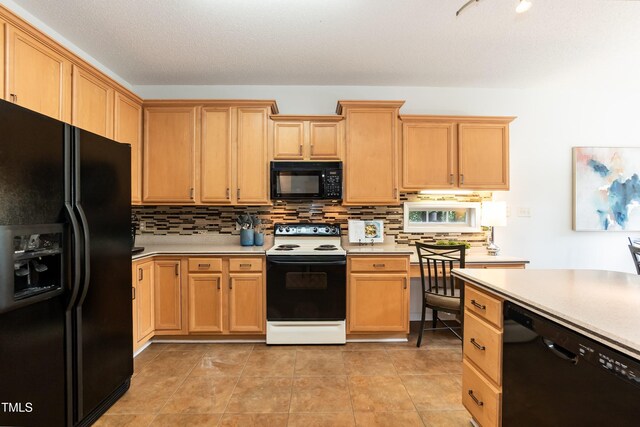 5501 Southern Cross Ave, Raleigh, NC 27606 - kitchen with black appliances, decorative backsplash, and light countertops