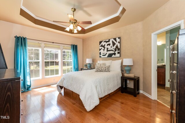 5501 Southern Cross Ave, Raleigh, NC 27606 - bedroom featuring wood finished floors, a raised ceiling, baseboards, crown molding, and ceiling fan