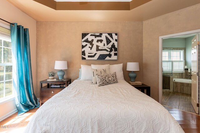 5501 Southern Cross Ave, Raleigh, NC 27606 - bedroom with multiple windows, wood finished floors, and ensuite bathroom