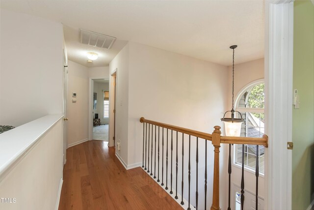 5501 Southern Cross Ave, Raleigh, NC 27606 - hall featuring wood finished floors, an upstairs landing, and baseboards
