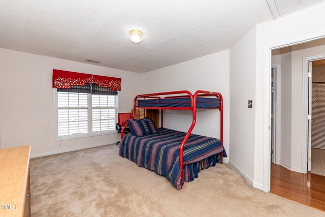 5501 Southern Cross Ave, Raleigh, NC 27606 - bedroom featuring carpet floors, baseboards, and a textured ceiling