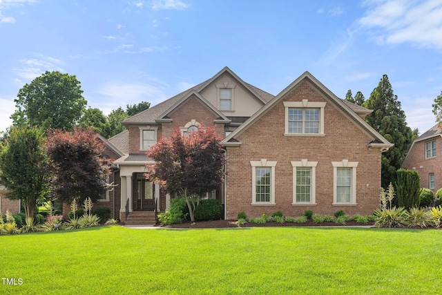1010 Mill Pointe Way, Elon, NC 27244 - traditional-style house featuring a front yard and brick siding