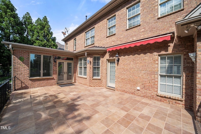 1010 Mill Pointe Way, Elon, NC 27244 - rear view of property featuring french doors, brick siding, and a patio area