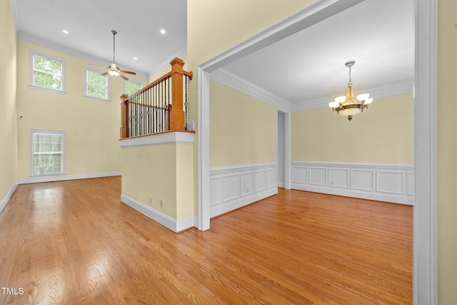 1010 Mill Pointe Way, Elon, NC 27244 - unfurnished room with crown molding, a chandelier, a ceiling fan, and wood finished floors