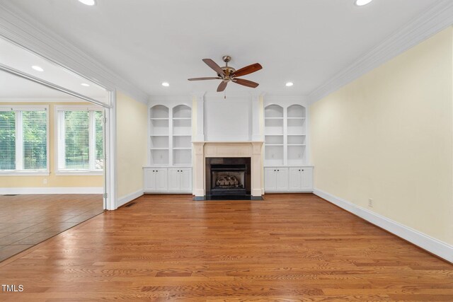 1010 Mill Pointe Way, Elon, NC 27244 - unfurnished living room featuring crown molding, a ceiling fan, a fireplace with flush hearth, baseboards, and recessed lighting