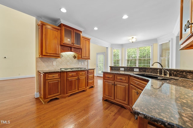 1010 Mill Pointe Way, Elon, NC 27244 - kitchen with a sink, brown cabinets, light wood-style floors, stainless steel gas stovetop, and crown molding