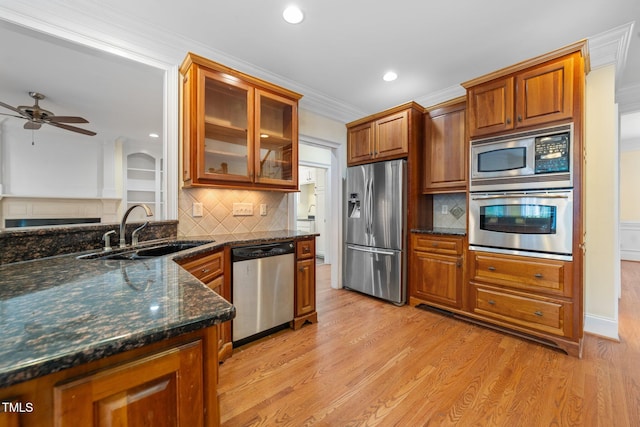 1010 Mill Pointe Way, Elon, NC 27244 - kitchen featuring stainless steel appliances, a sink, backsplash, brown cabinetry, and recessed lighting