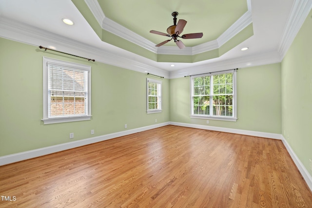 1010 Mill Pointe Way, Elon, NC 27244 - unfurnished room featuring ornamental molding, a raised ceiling, light wood-style floors, baseboards, and a ceiling fan