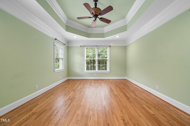 1010 Mill Pointe Way, Elon, NC 27244 - empty room with ornamental molding, a tray ceiling, wood finished floors, and baseboards