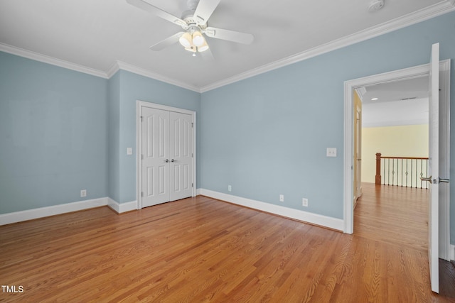 1010 Mill Pointe Way, Elon, NC 27244 - unfurnished bedroom featuring ornamental molding, light wood finished floors, baseboards, a closet, and a ceiling fan