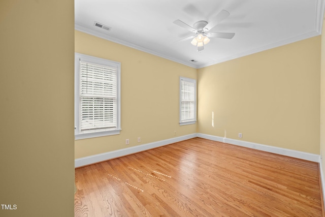 1010 Mill Pointe Way, Elon, NC 27244 - spare room with crown molding, light wood-style floors, ceiling fan, and baseboards