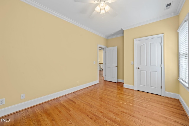1010 Mill Pointe Way, Elon, NC 27244 - unfurnished bedroom featuring light wood finished floors, crown molding, baseboards, multiple windows, and ceiling fan