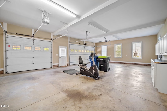 1010 Mill Pointe Way, Elon, NC 27244 - garage featuring a garage door opener and baseboards