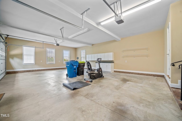 1010 Mill Pointe Way, Elon, NC 27244 - garage featuring baseboards and a garage door opener