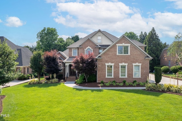 1010 Mill Pointe Way, Elon, NC 27244 - view of front facade with a front yard and brick siding