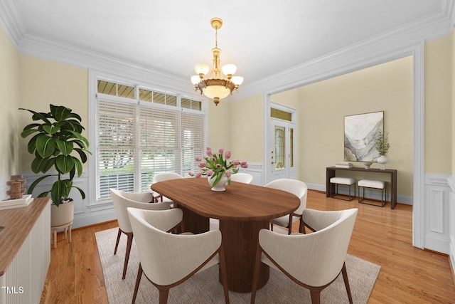 1010 Mill Pointe Way, Elon, NC 27244 - dining space with crown molding, a chandelier, light wood-style flooring, and a wainscoted wall