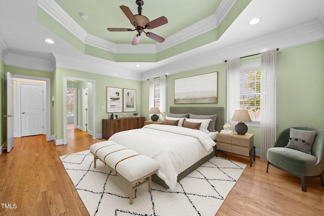 1010 Mill Pointe Way, Elon, NC 27244 - bedroom with crown molding, a raised ceiling, baseboards, light wood finished floors, and ceiling fan