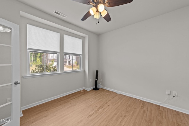 empty room with light wood-style floors, baseboards, and a ceiling fan